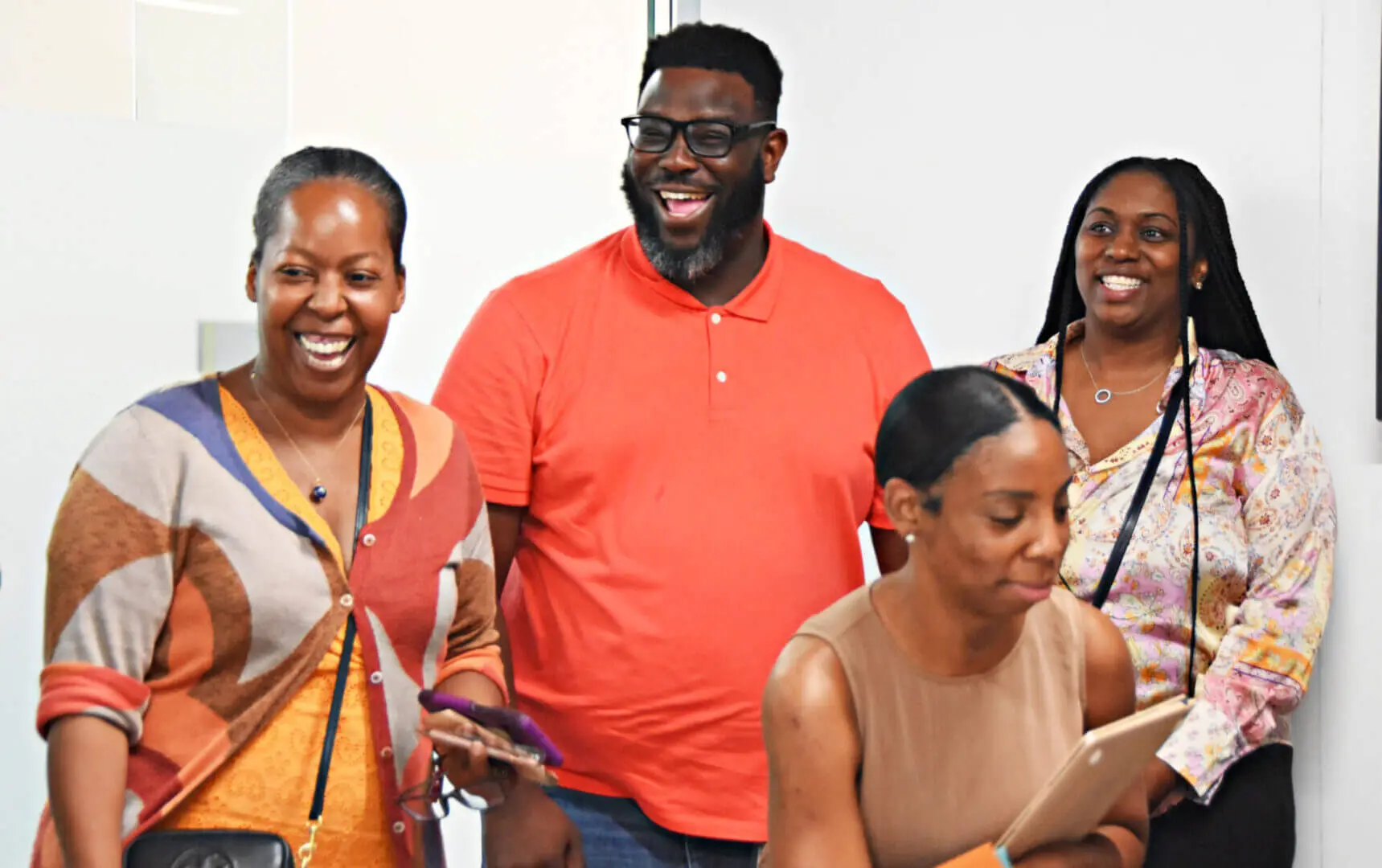 Four friends laughing and enjoying a casual moment together.