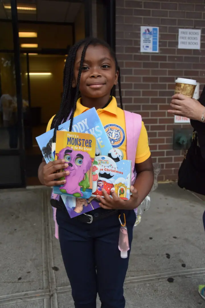 Young girl proudly displays colorful badges and patches.