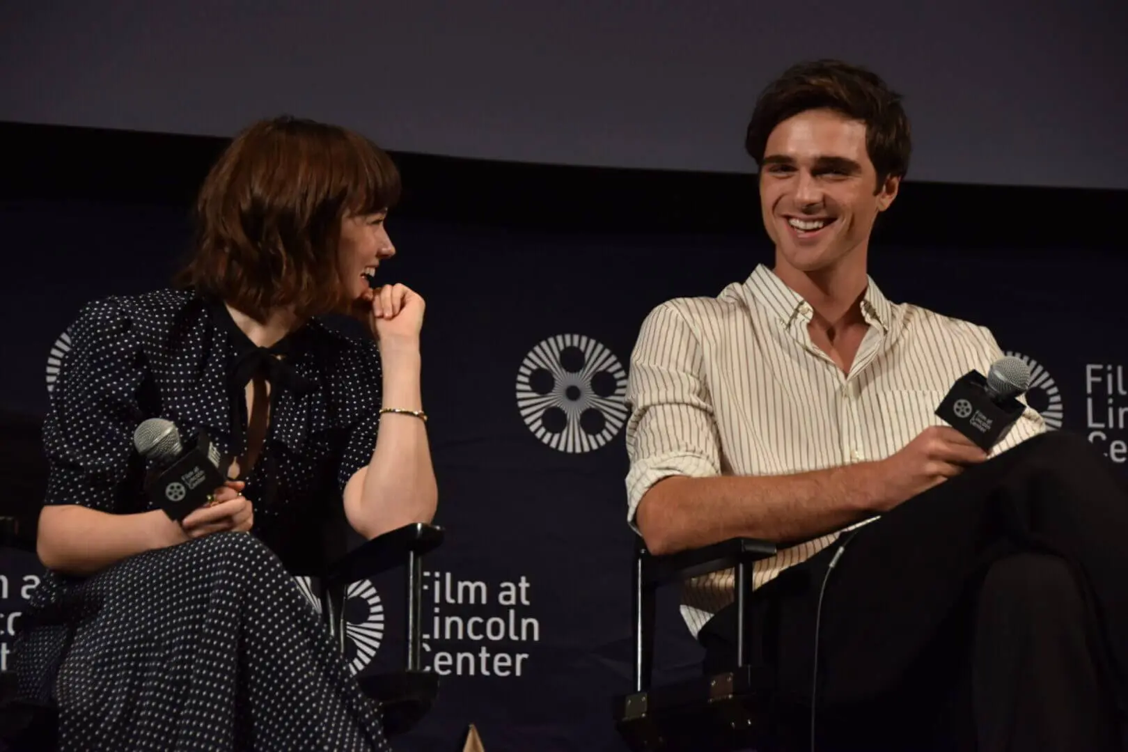 Two people engaged in a discussion at a film event.