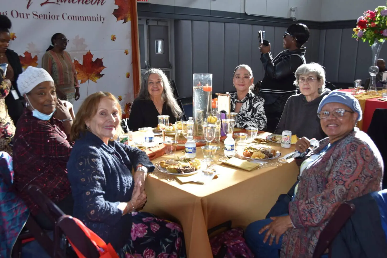 A group of women enjoying a meal together around a table.