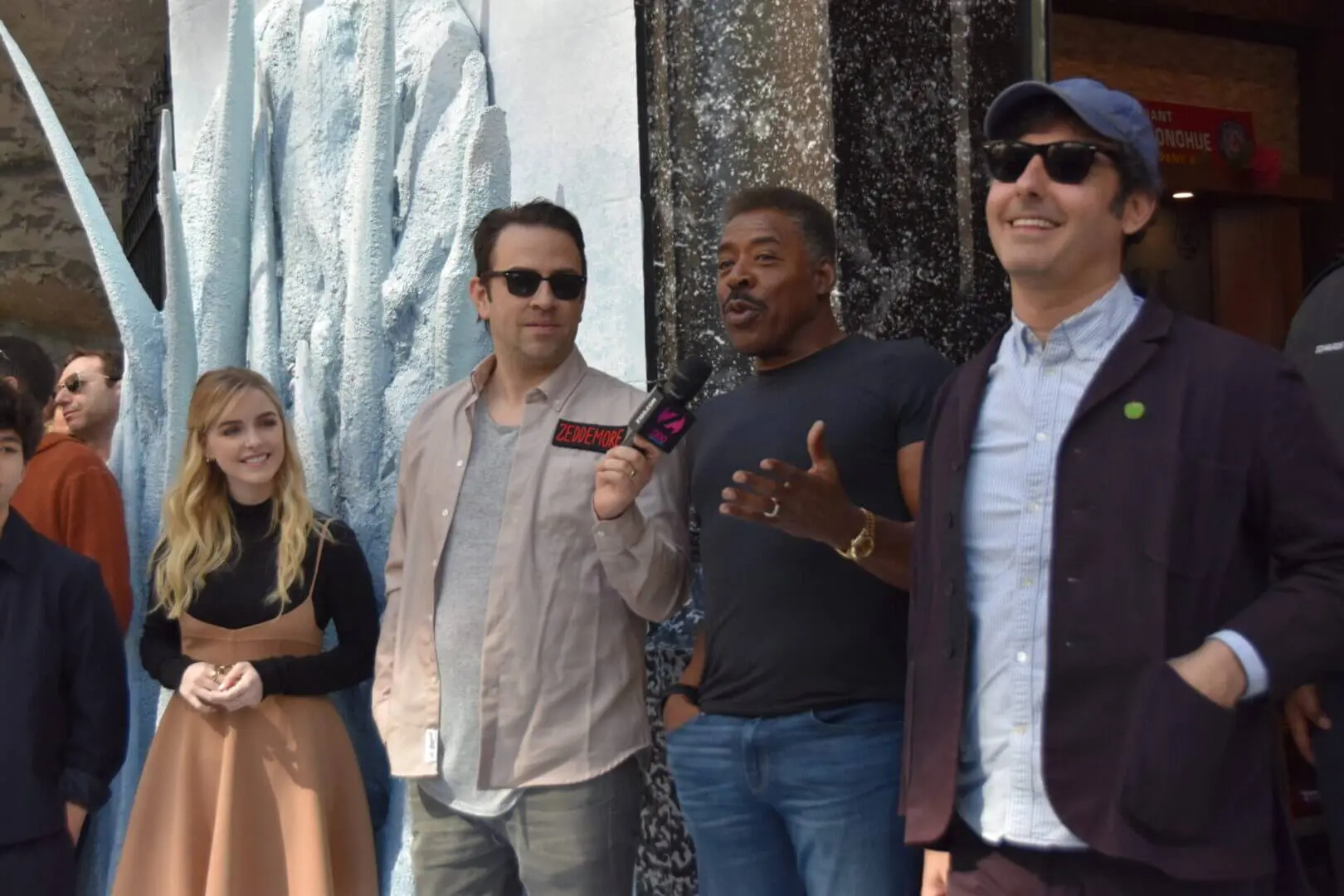 Four friends posing together outdoors, smiling and enjoying their time.