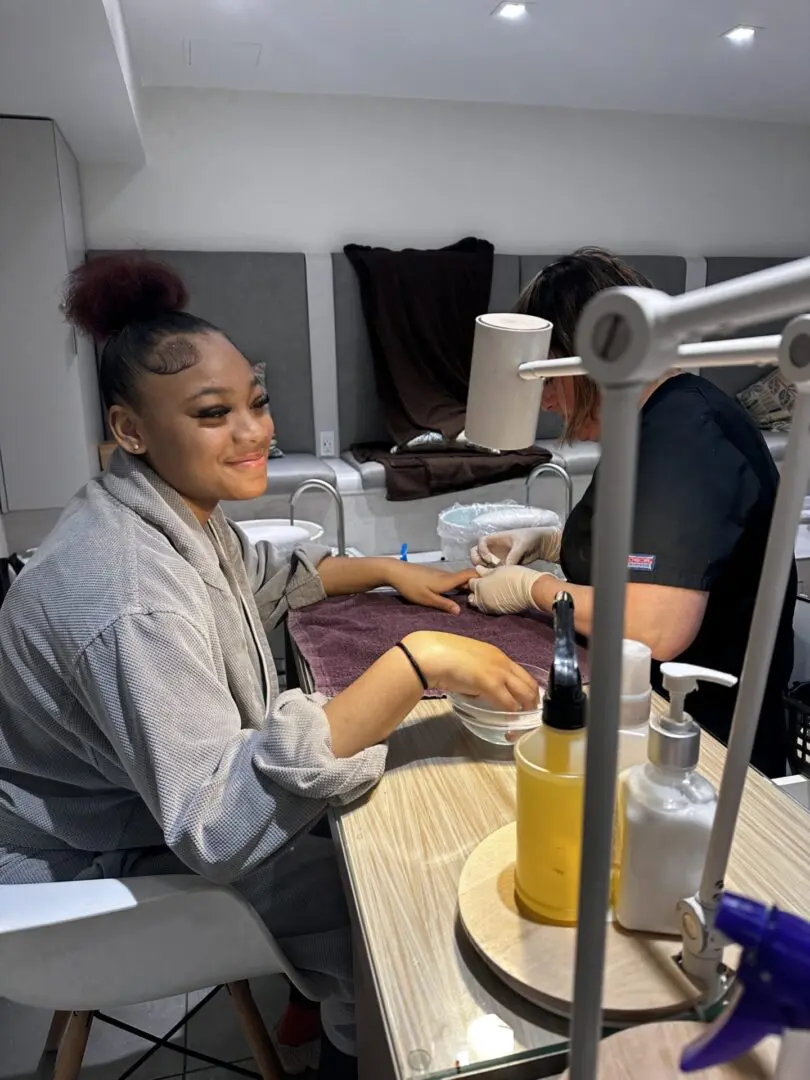 Woman getting a manicure at a salon.