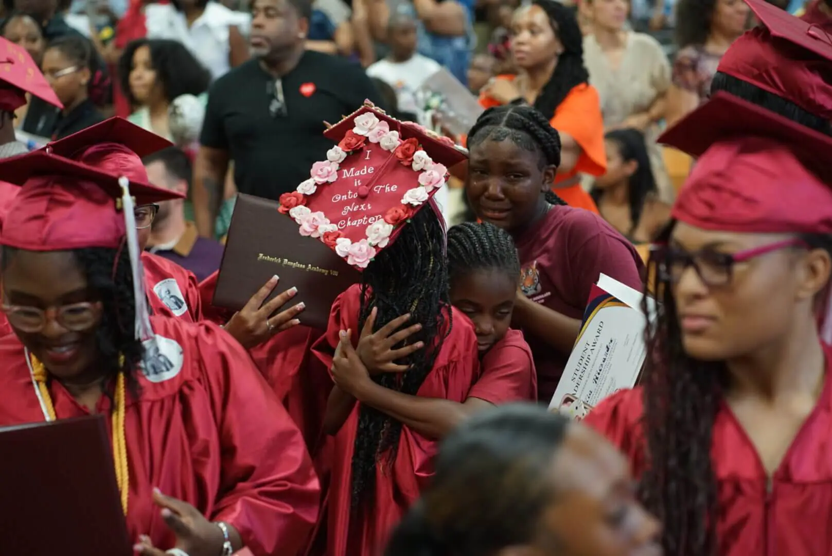 People mourning and carrying a casket adorned with flowers.