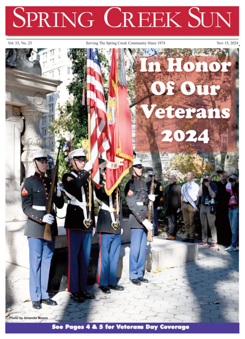 Veterans honored in a 2024 ceremony with flag bearers and a crowd.