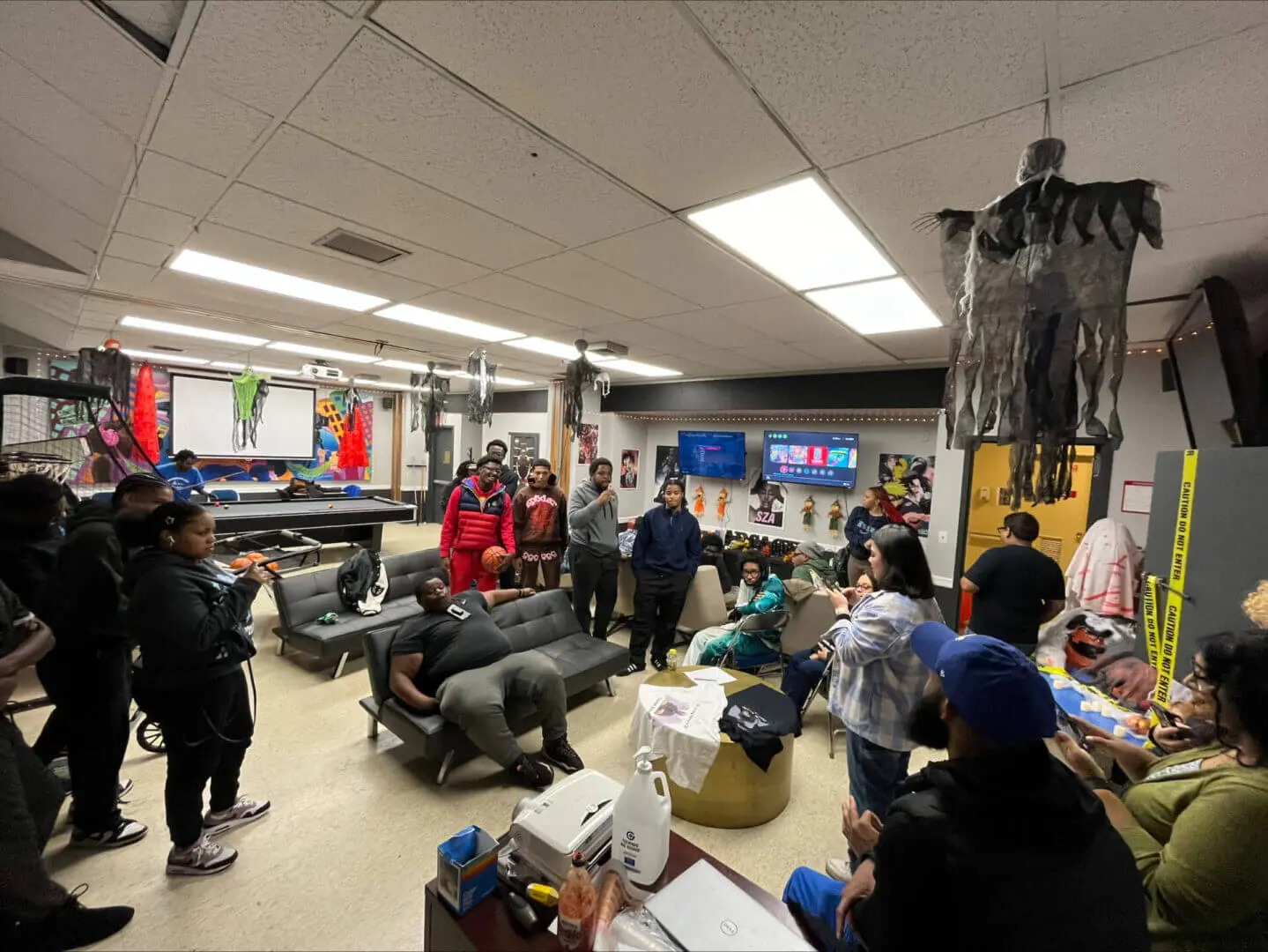 Students engaged in a lively classroom discussion with a teacher.