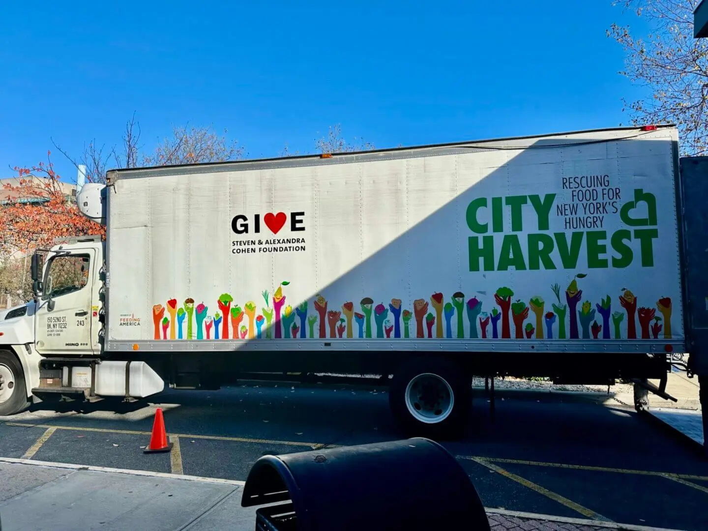 City Harvest truck promoting food donation with colorful graphics.