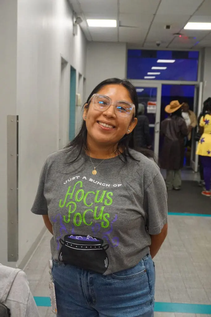 Smiling woman wearing Hocus Pocus t-shirt.