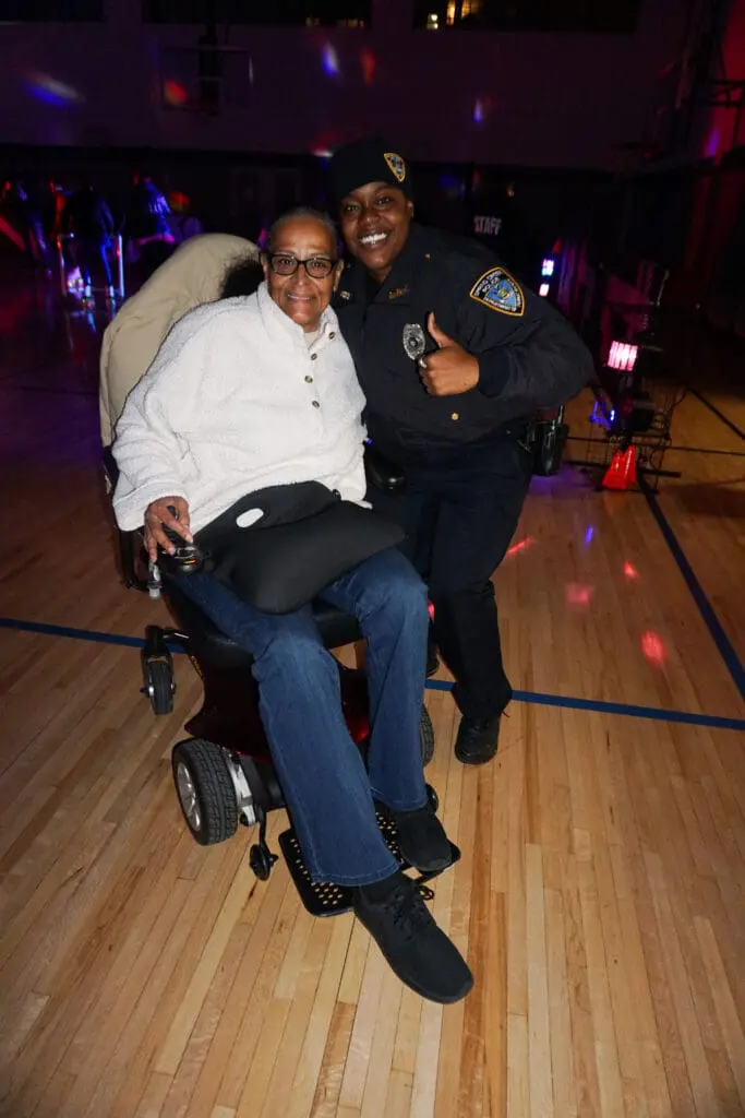 Person in wheelchair with smiling officer.