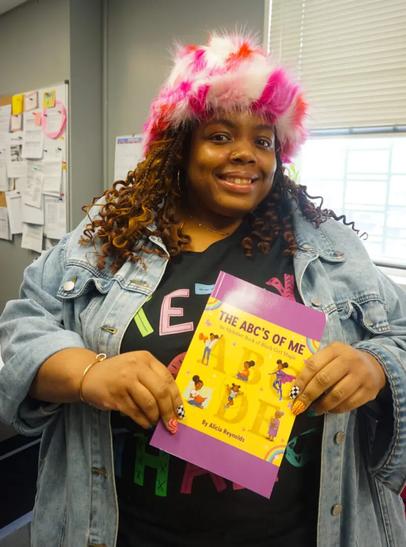 Person holding a colorful children's book.