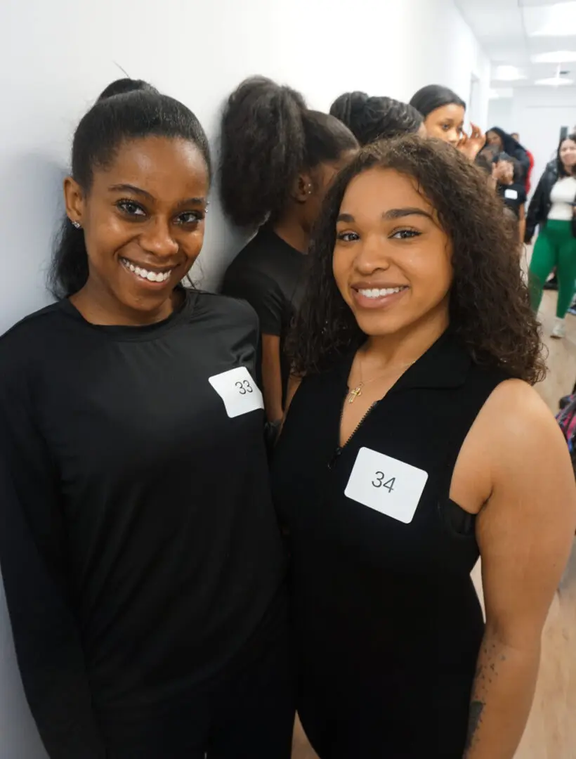 Two women smiling at an event.